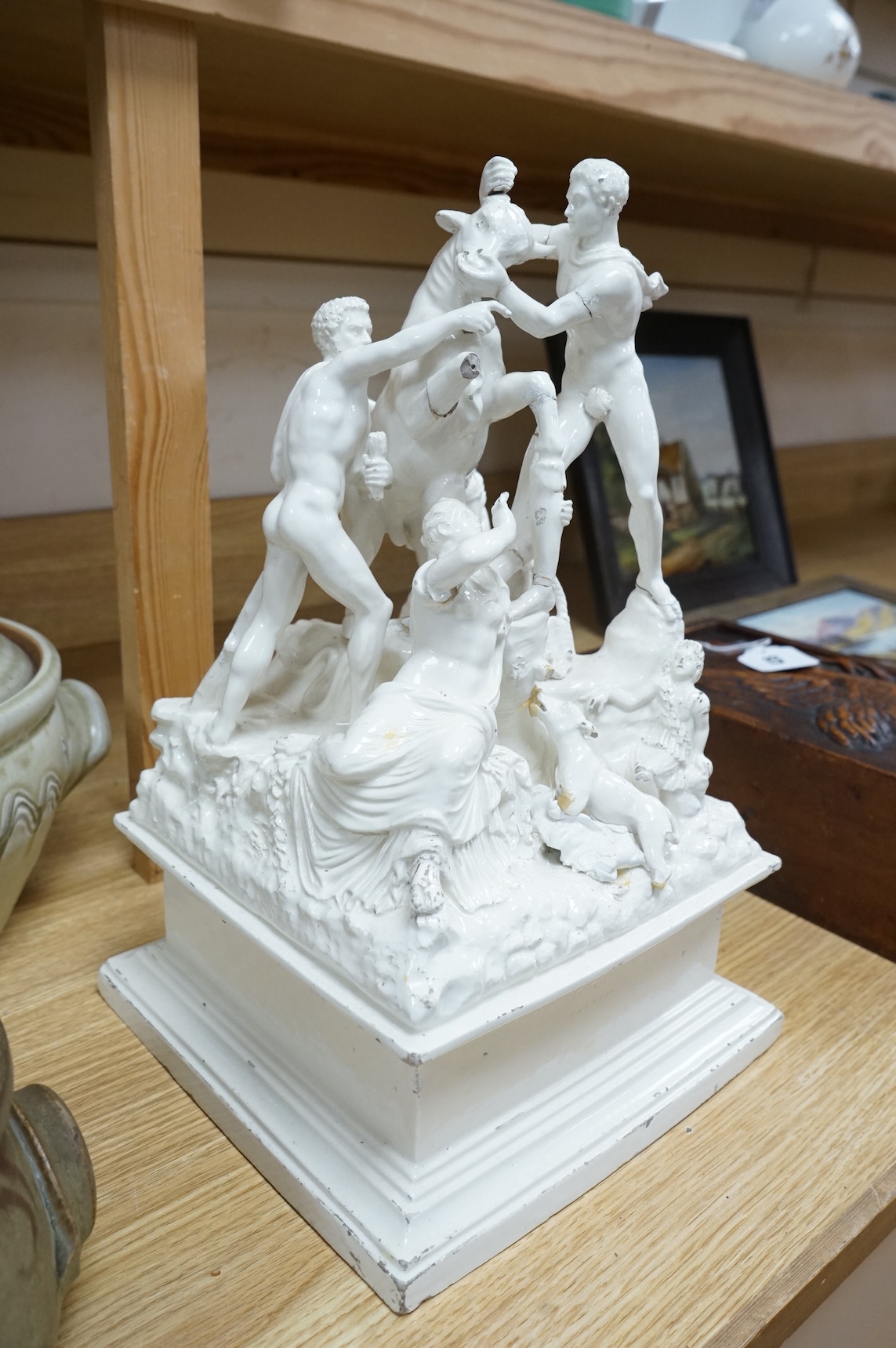 A 19th century Naples tin glazed pottery group of figures wrestling a Europa and the bull, 14in.